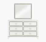 White dresser with silver trim and matching mirror on a white background