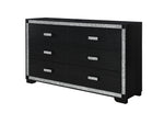 Black dresser with silver glittery trim on a white background