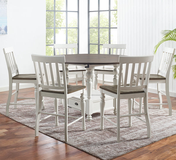 Dining room with a round table and six chairs on a wooden floor.