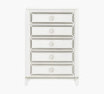 White dresser with decorative trim on a white background